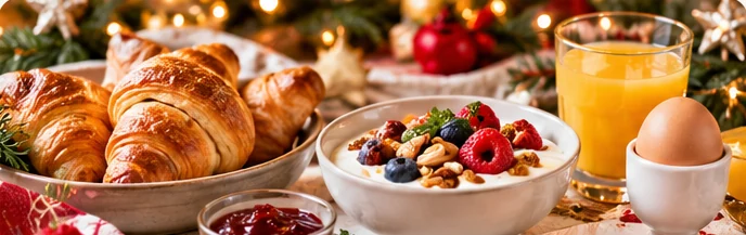 Kerstontbijt met broodjes, fruit en eieren op een feestelijk gedekte tafel